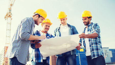 Construction workers reading building plans