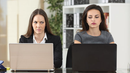 Two annoyed female colleagues