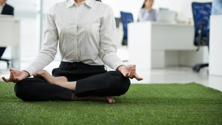 A businesswoman practising yoga in the office