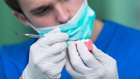 A close-up of an orthodontist working on a patient's dentures