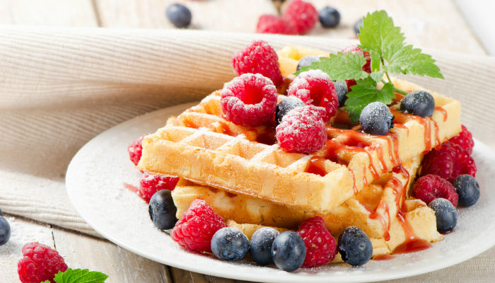 A plate of waffles with berries