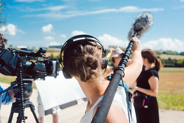 Boom operator working on a film set
