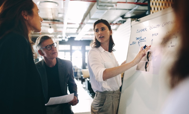 Marketing director explaining something on a whiteboard