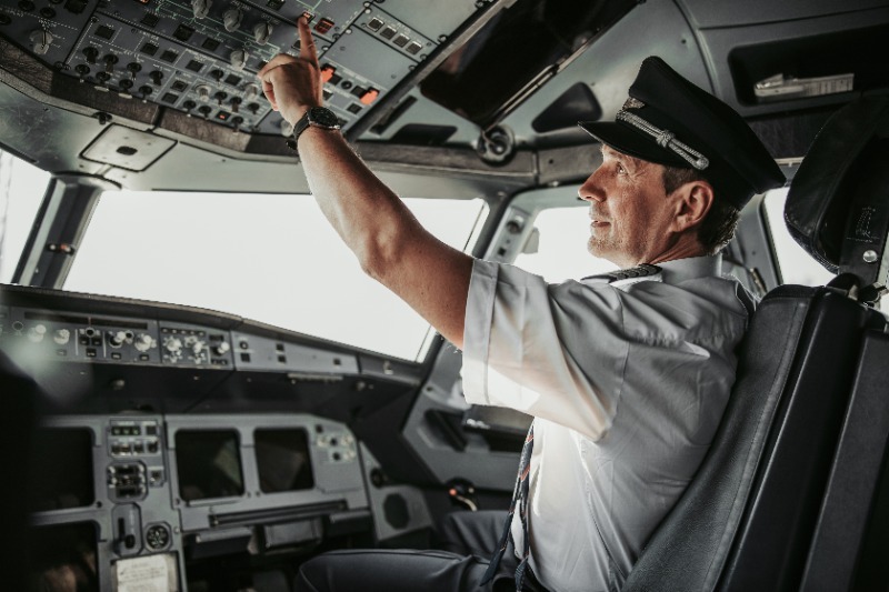 Pilot pressing sitting in a cockpit