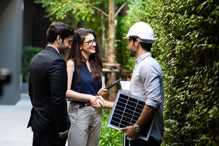 Solar energy specialist shaking hands with clients
