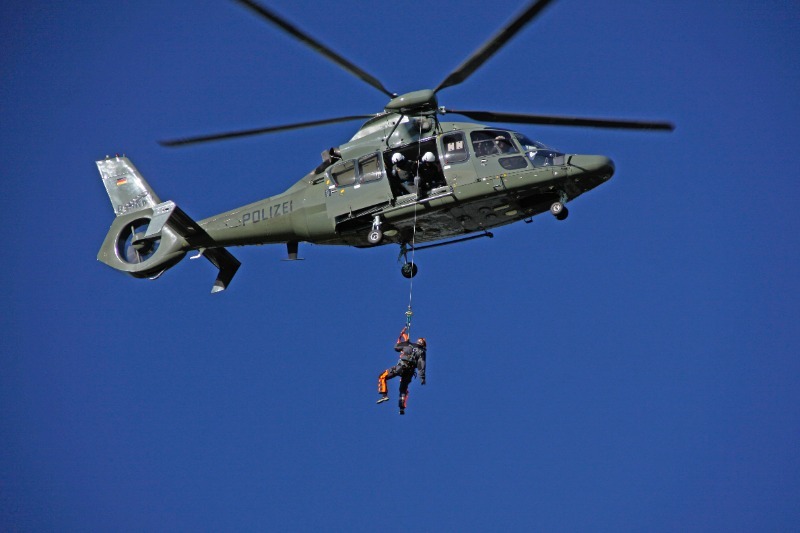 Pararescue tied to a military helicopter